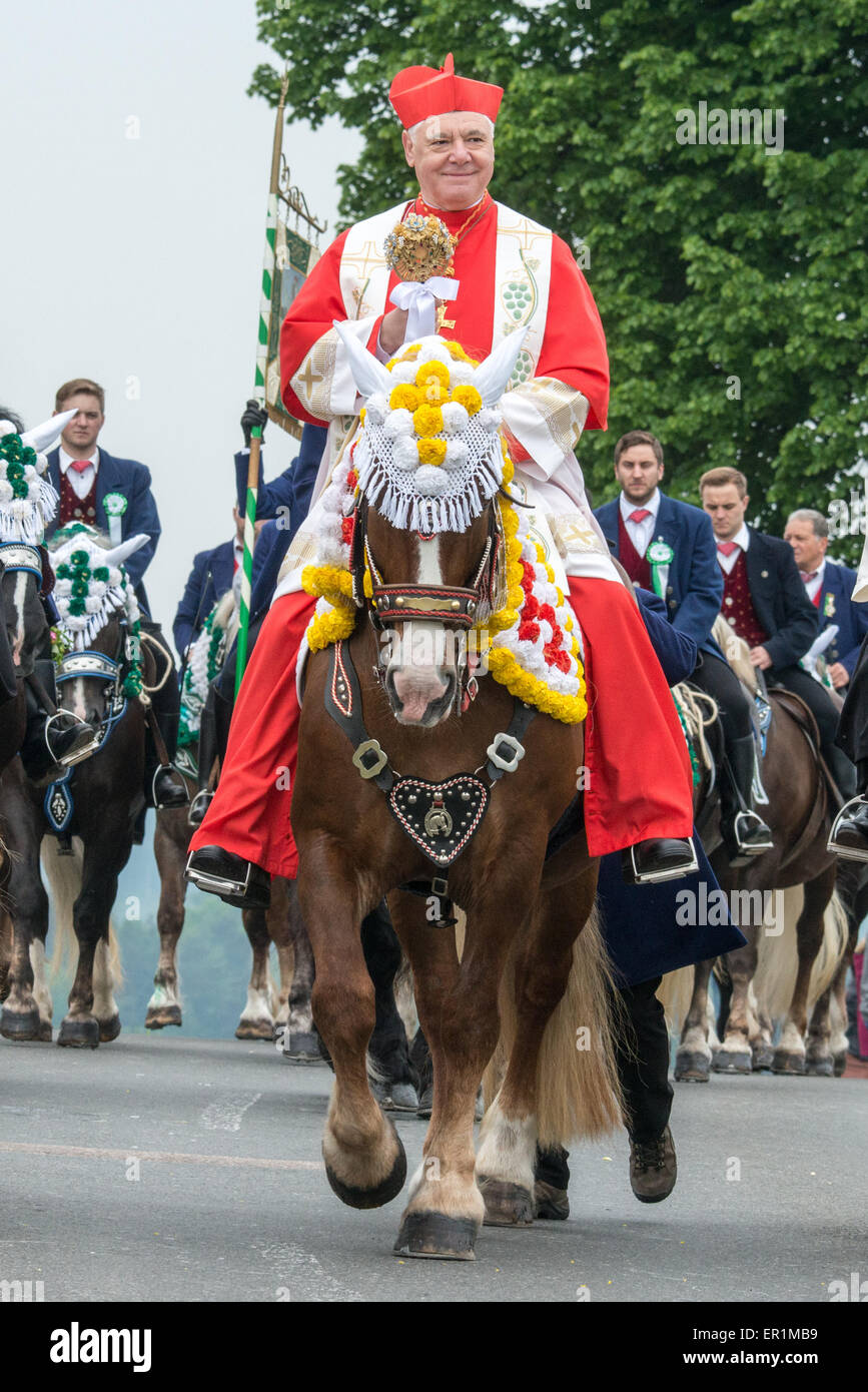 Bad Koetzting, Germany. 25th May, 2015. Cardinal Gerhard Ludwig Mueller participates in the Pentecost Ride near Bad Koetzting, Germany, 25 May 2015. The procession with some 900 riders is one of the oldest Bavarian traditional events. The men pilgrim on their beautifully decorated horses from Bad Koetzting to the Nikolaus church in Steinbuehl on a distance of seven kilometres. Photo: ARMIN WEIGEL/dpa/Alamy Live News Stock Photo