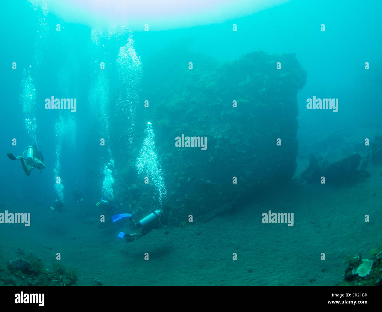 Group of scuba divers exploring the famous ship wreck USS Liberty at Tulamben on Bali, Indonesia Stock Photo