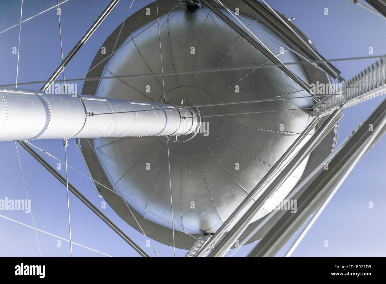 Low angle view of old metal water tower against a clear blue sky Stock Photo