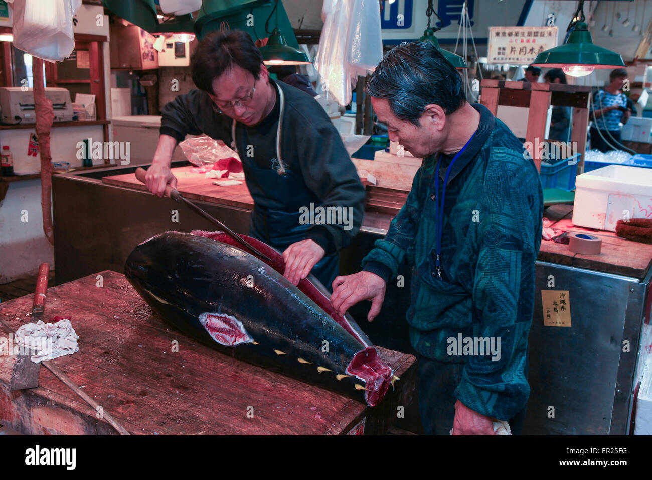 Fresh Tuna main cut by professional Japanese tuna handlers at Tsukiji fish and seafood market, right after the Tuna auction. Stock Photo