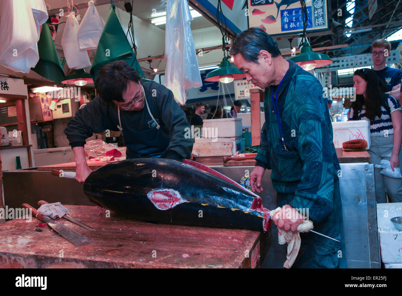 Fresh Tuna main cut by professional Japanese tuna handlers at Tsukiji fish and seafood market, right after the Tuna auction. Stock Photo