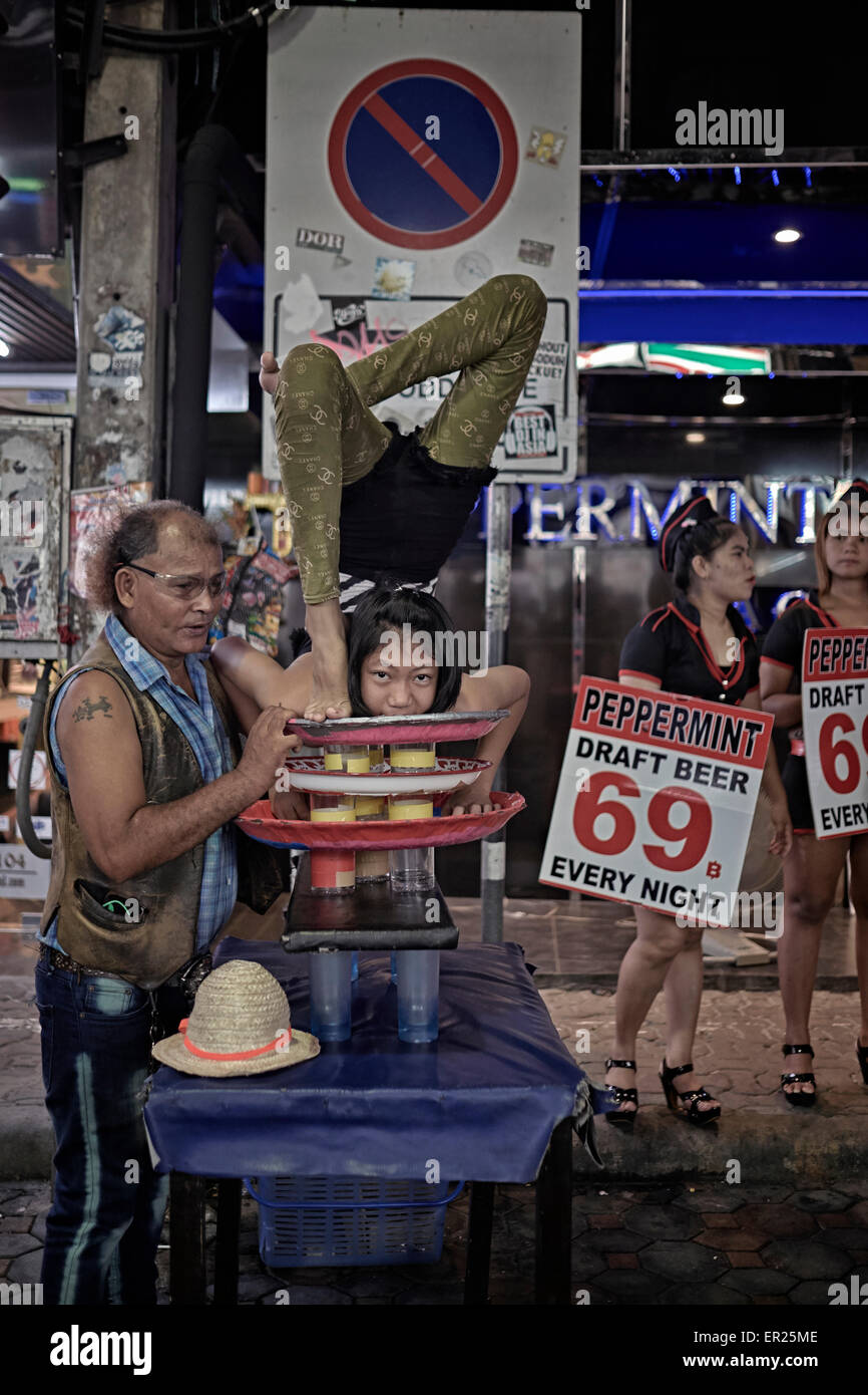 Contortionist child performing at a night street venue. Extreme flexibility. Thailand S. E. Asia Stock Photo