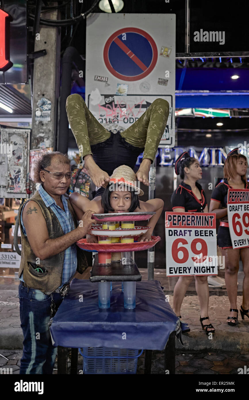 Contortionist child performing at a night street venue. Extreme flexibility. Thailand S. E. Asia Stock Photo