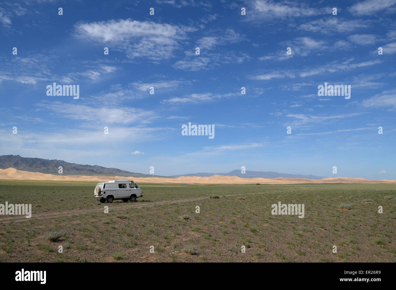 My car before the Khongoryn sand dunes in the Gobi desert, Omnogovi province, Mongolia. Stock Photo