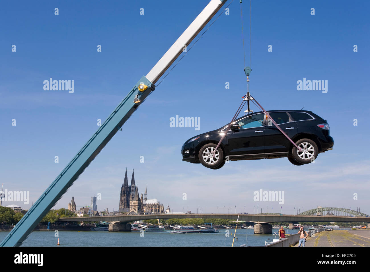 Europe, Germany, Cologne, a boatman at the bank of the river Rhine lands his car, in the background Cologne cathedral.   Europa, Stock Photo