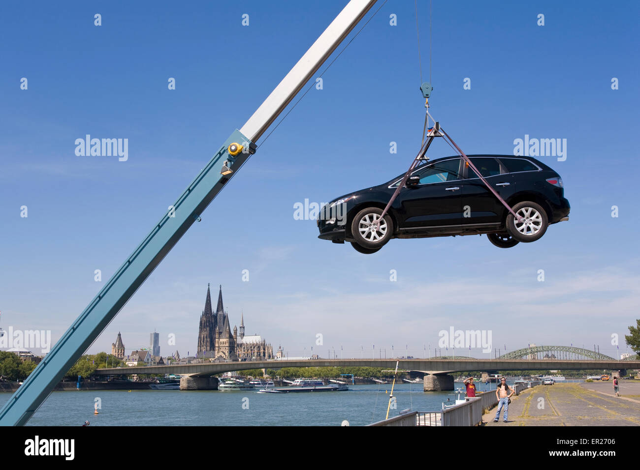 Europe, Germany, Cologne, a boatman at the bank of the river Rhine lands his car, in the background Cologne cathedral.   Europa, Stock Photo