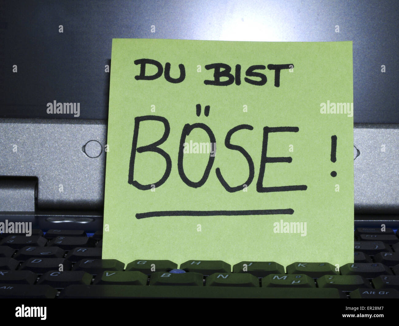 Memo note on notebook, Du bist böse you are mean Stock Photo Alamy