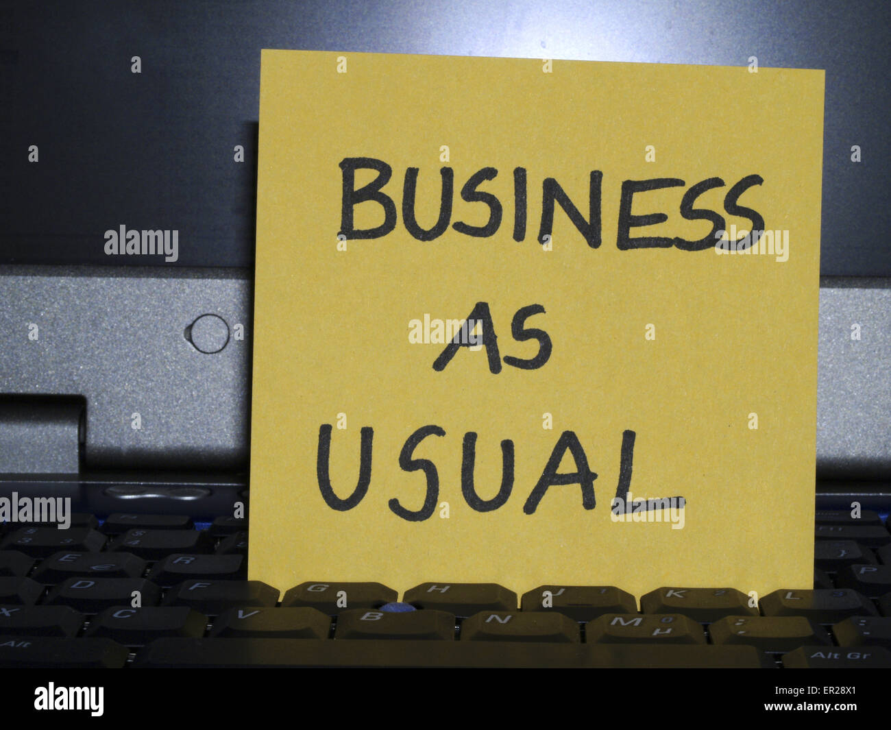 Memo note on notebook, business as usual Stock Photo Alamy
