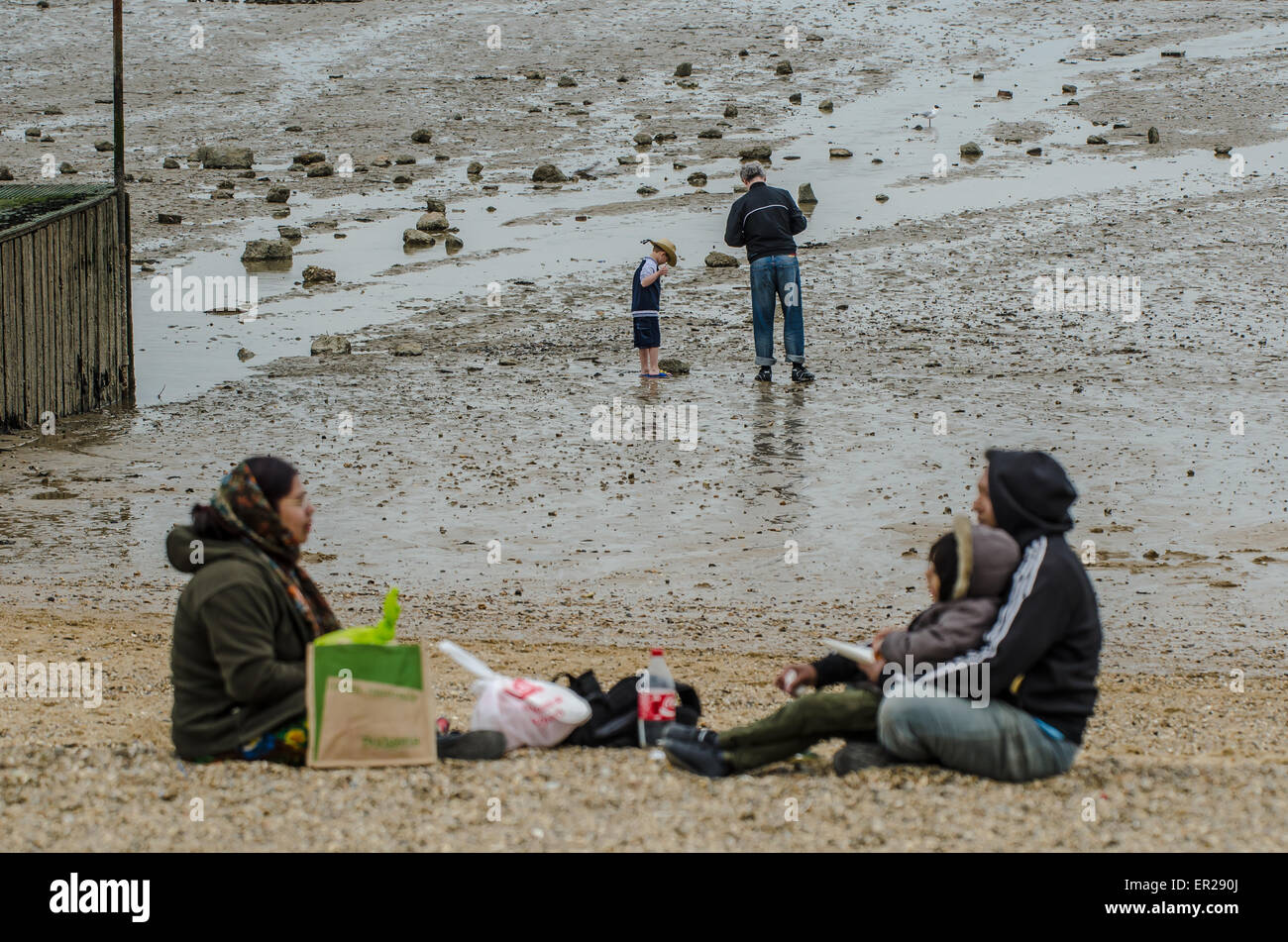 Visitors to the Southend-on-Sea, Essex seaside resort on the Bank Holiday Monday make the best of the overcast weather on the beach Stock Photo