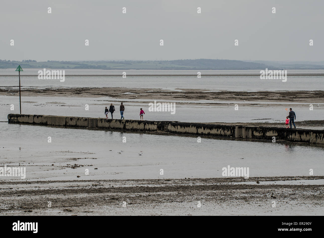 Visitors to the Southend-on-Sea, Essex seaside resort on the Bank Holiday Monday make the best of the overcast weather on the beach Stock Photo