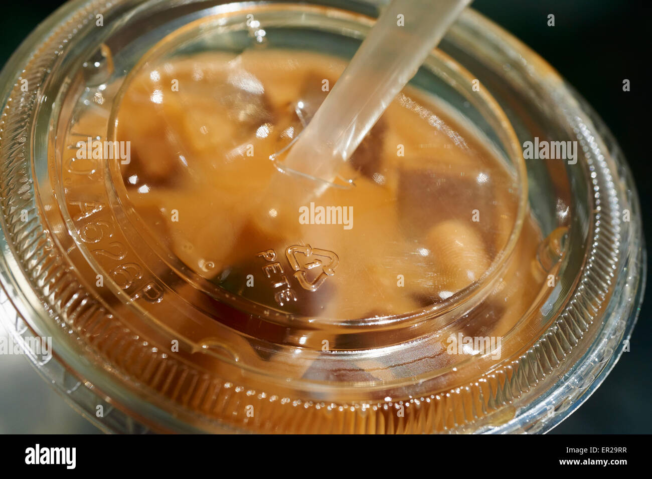 Iced coffee in a plastic container, a typical warm-weather NYC drink packed for street consumption Stock Photo