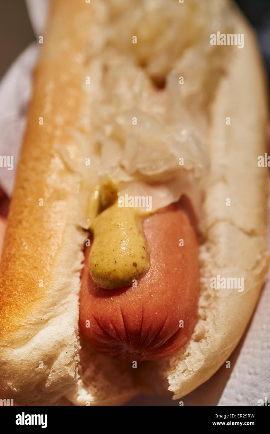 A New York City style 'dirty water' boiled hot dog with mustard and sauerkraut on a bun from a Manhattan street vendor Stock Photo