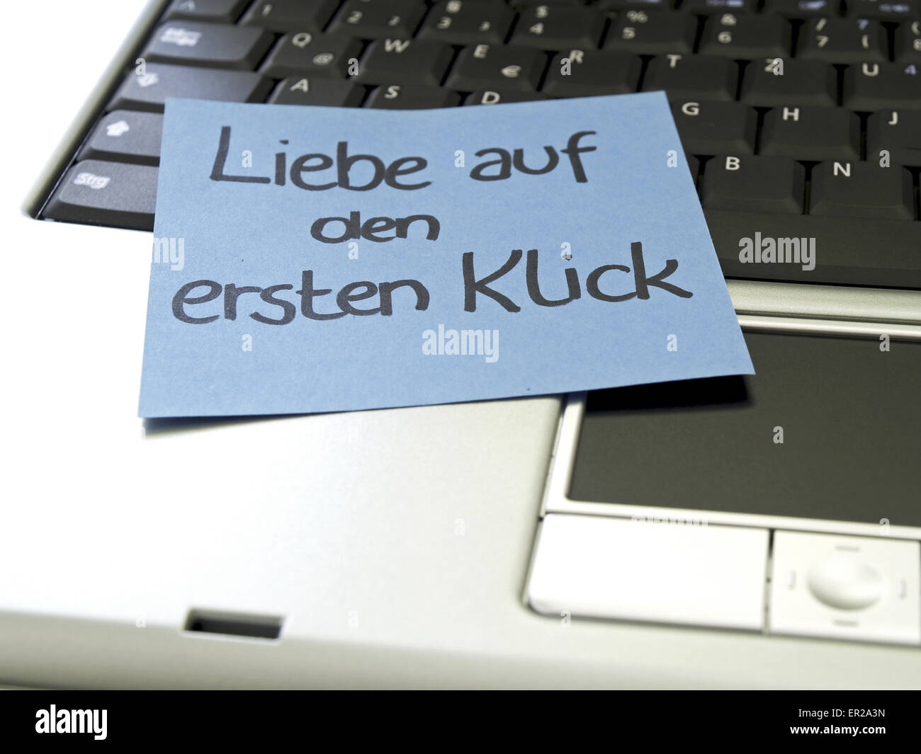 Memo note on notebook, love at first klick Stock Photo - Alamy