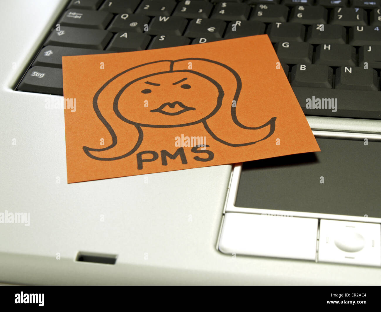 Memo note on notebook, drawing of woman´s face sign PMS Stock Photo
