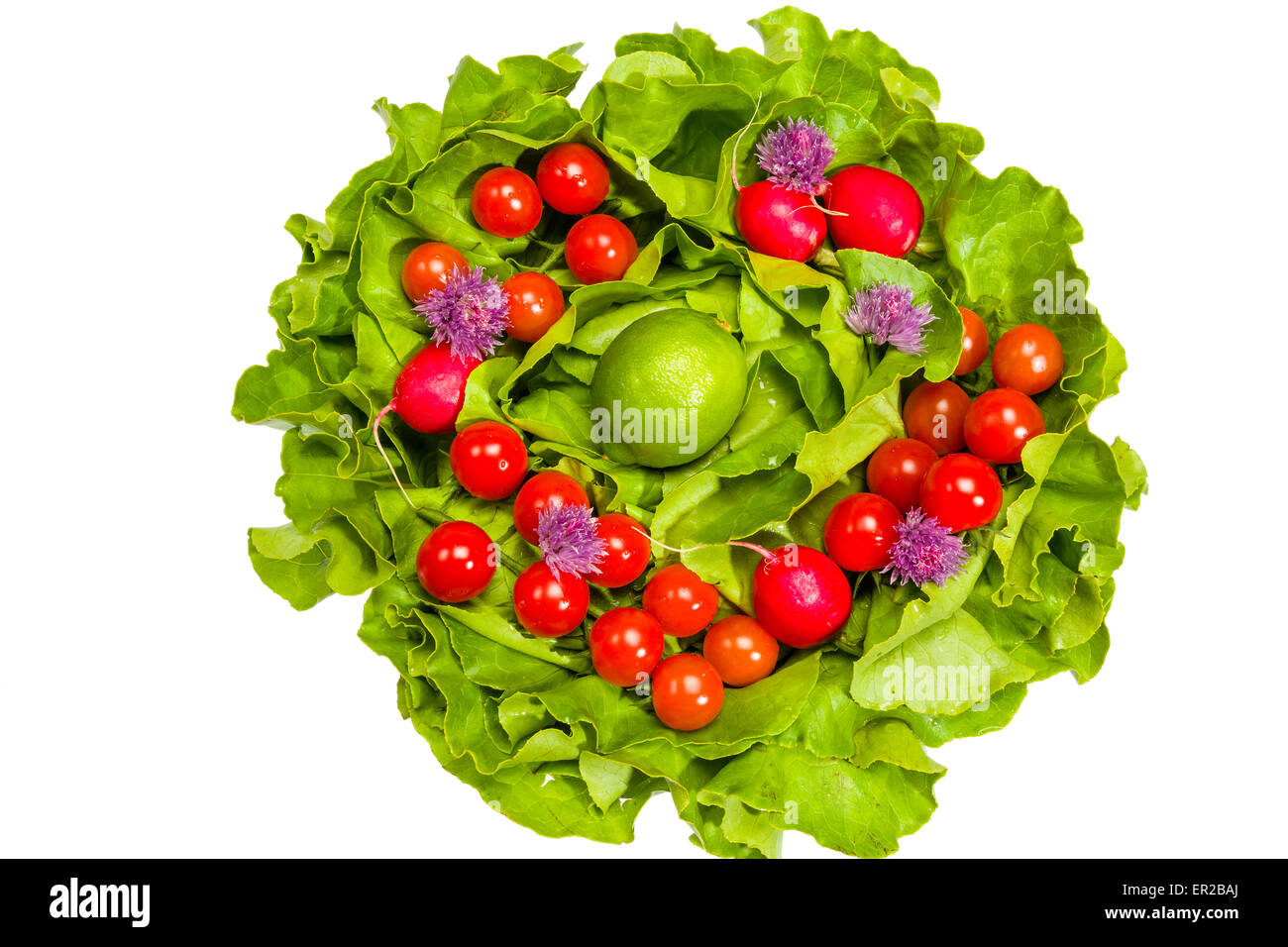 Lettuce, radishes, chives, lime and cherry tomatoes Stock Photo