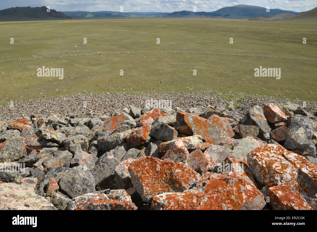 View from the top of a burial mound in the Arhangay province, central Mongolia. A stone circle around the monument is visible. Stock Photo