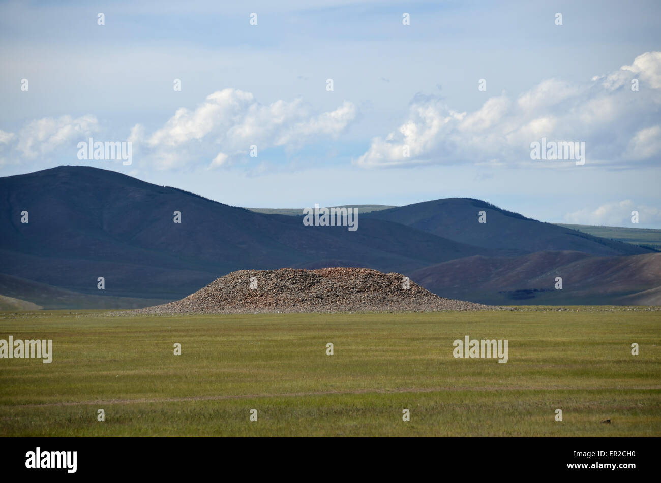 A burial mound in the Arhangay province, central Mongolia. This kind of monument is also called kurgan. Stock Photo