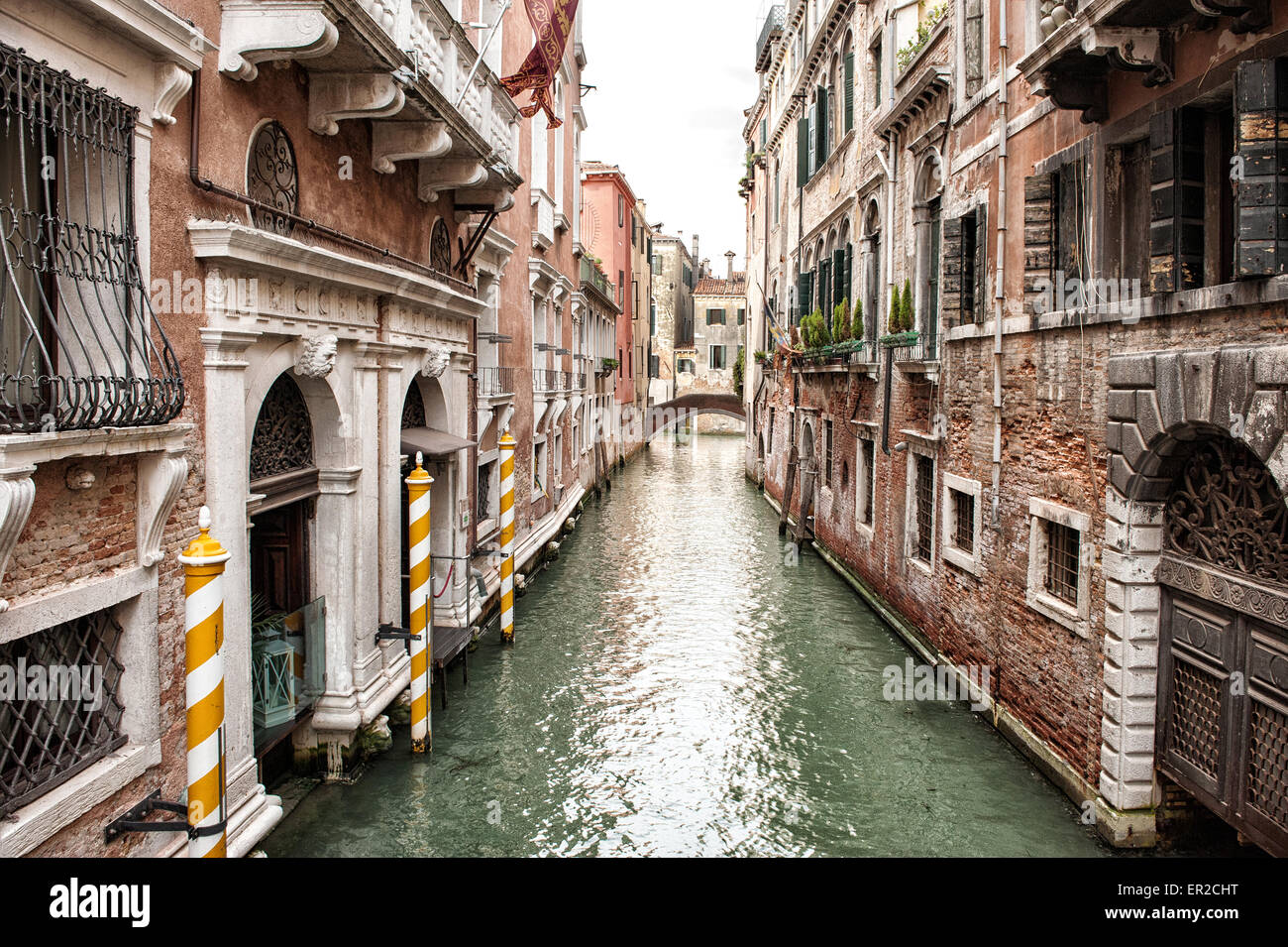 Narrow Canal Lined with Low Rise Buildings, Iconic Canal Scene in Venice, Italy Stock Photo