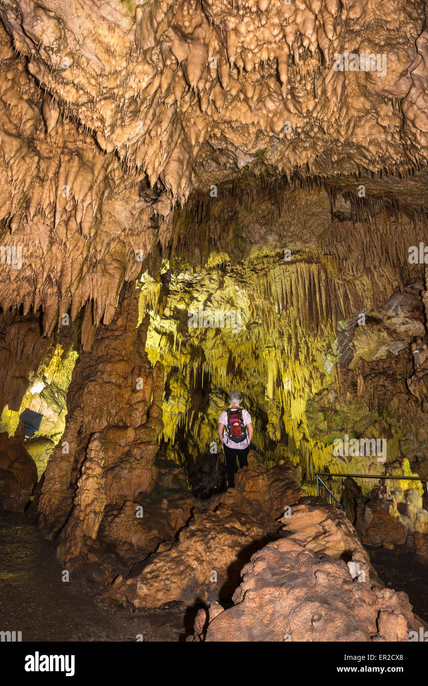 A visitor views the Stalactites in the Diros cave near Pirgos Dirou in the Deep Mani, Southern Peloponnese, Greece Stock Photo