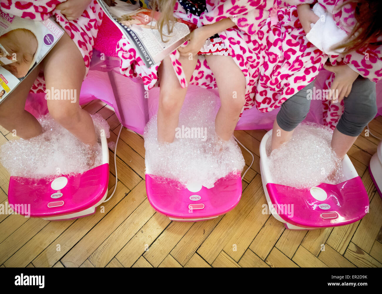 Young children having a foot spa session with bubbles Stock Photo
