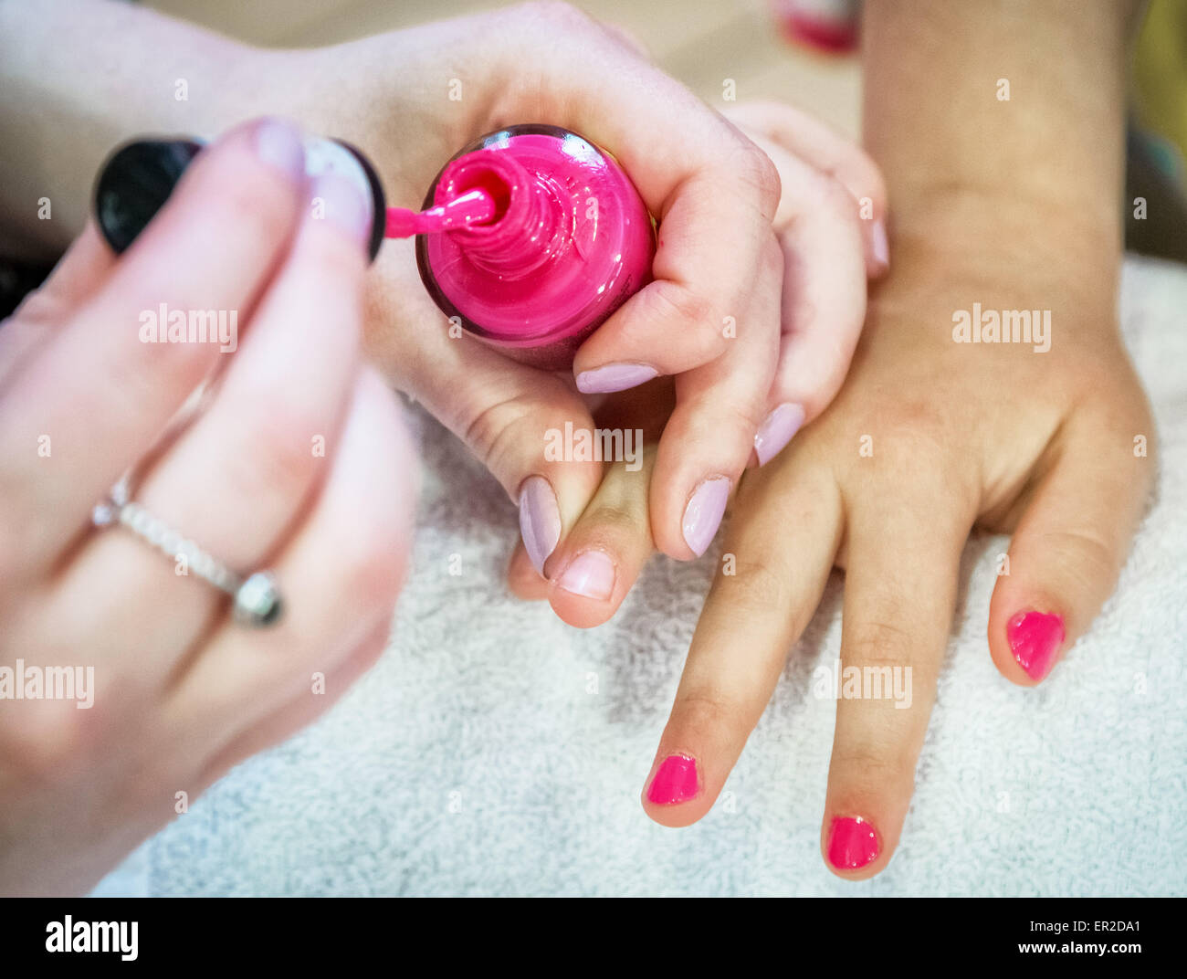 Young child receiving nail polish during a manicure / spa day beauty