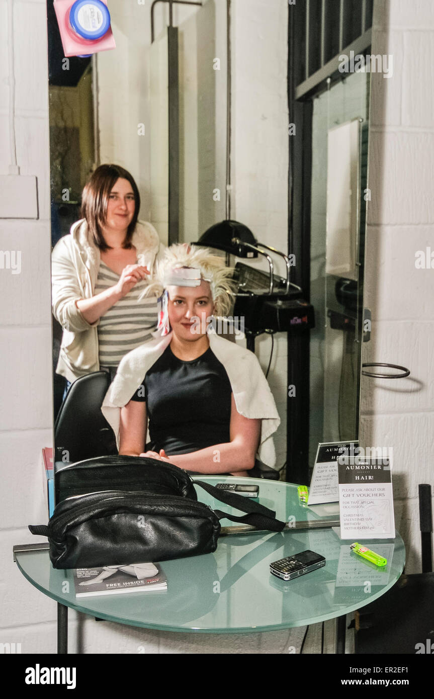 A girl has her hair dyed at a hairdressers. Stock Photo