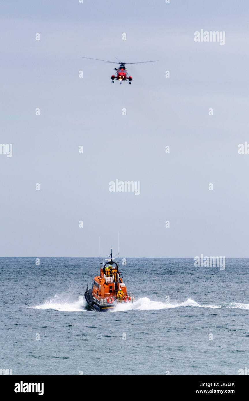Helicopter and RNLB lifeboat during a rescue operation Stock Photo