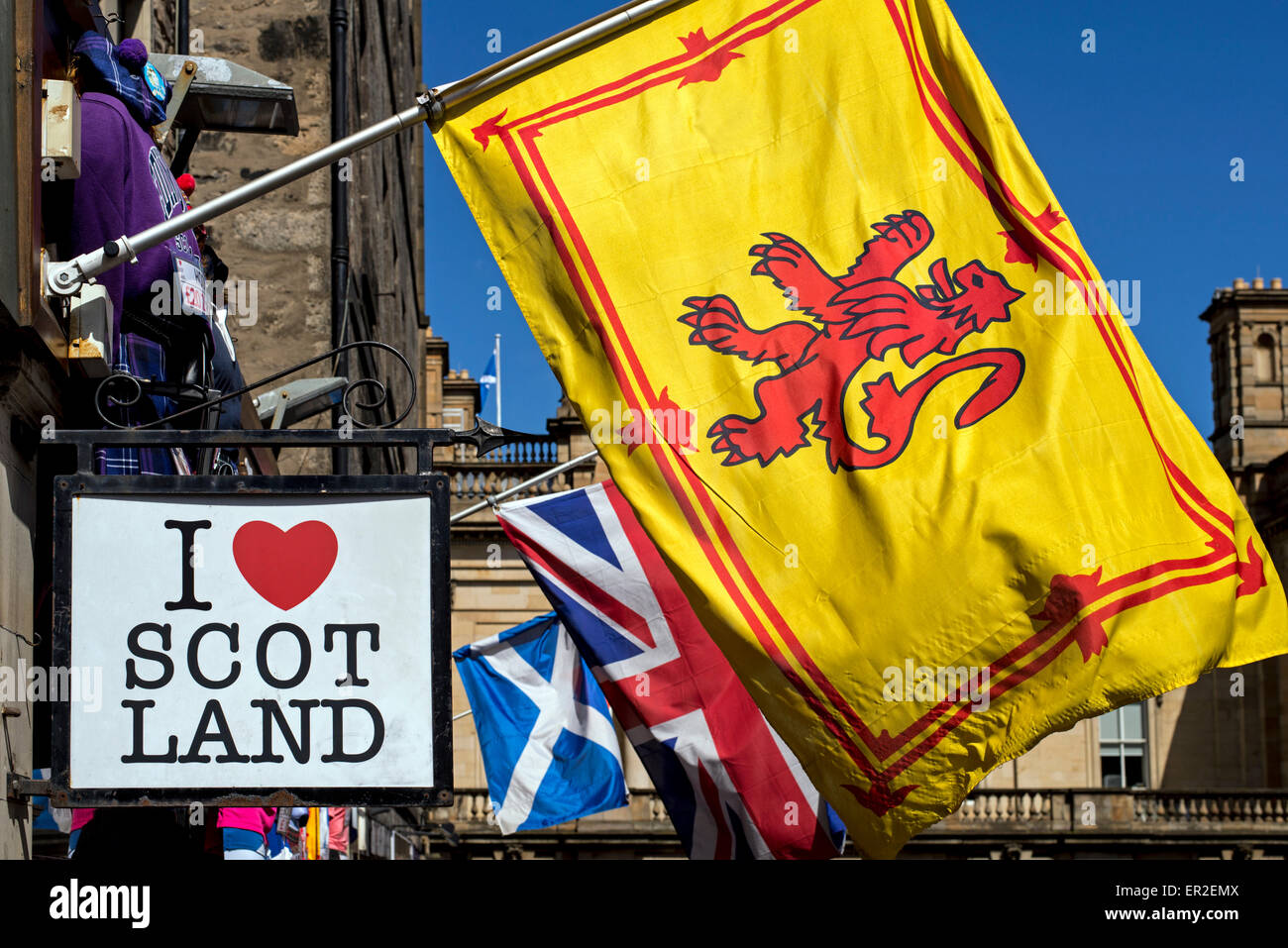 Lion Rampant, Union Jack and the Scottish Saltire flying outside a tourist souvenir shop in Edinburgh's Old Town. Stock Photo