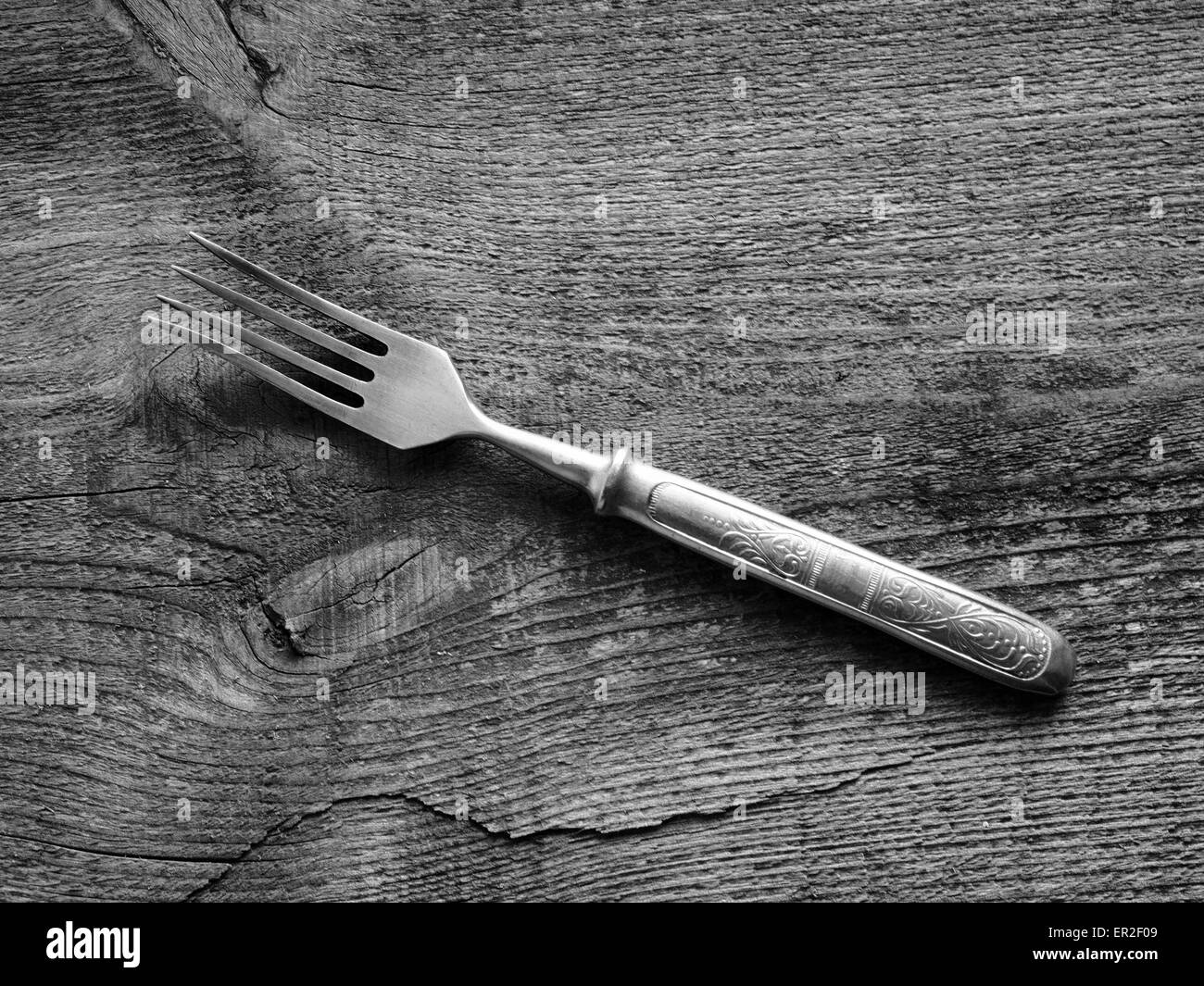 Dining fork on raw wooden background. Grunge style. 24th May, 2015. © Igor Golovniov/ZUMA Wire/Alamy Live News Stock Photo
