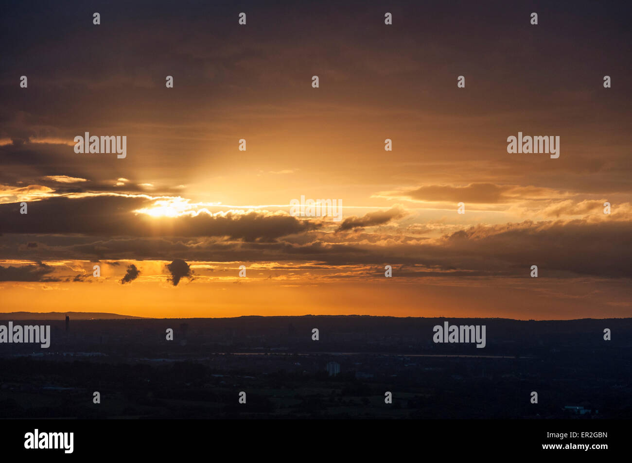 Dramatic sunset over the city of Manchester as seen from the hills of North Derbyshire. Stock Photo