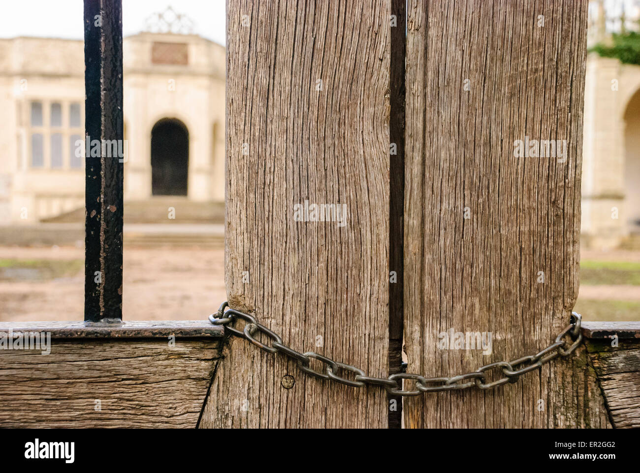 Chain locking a wooden gate outside a building. Stock Photo