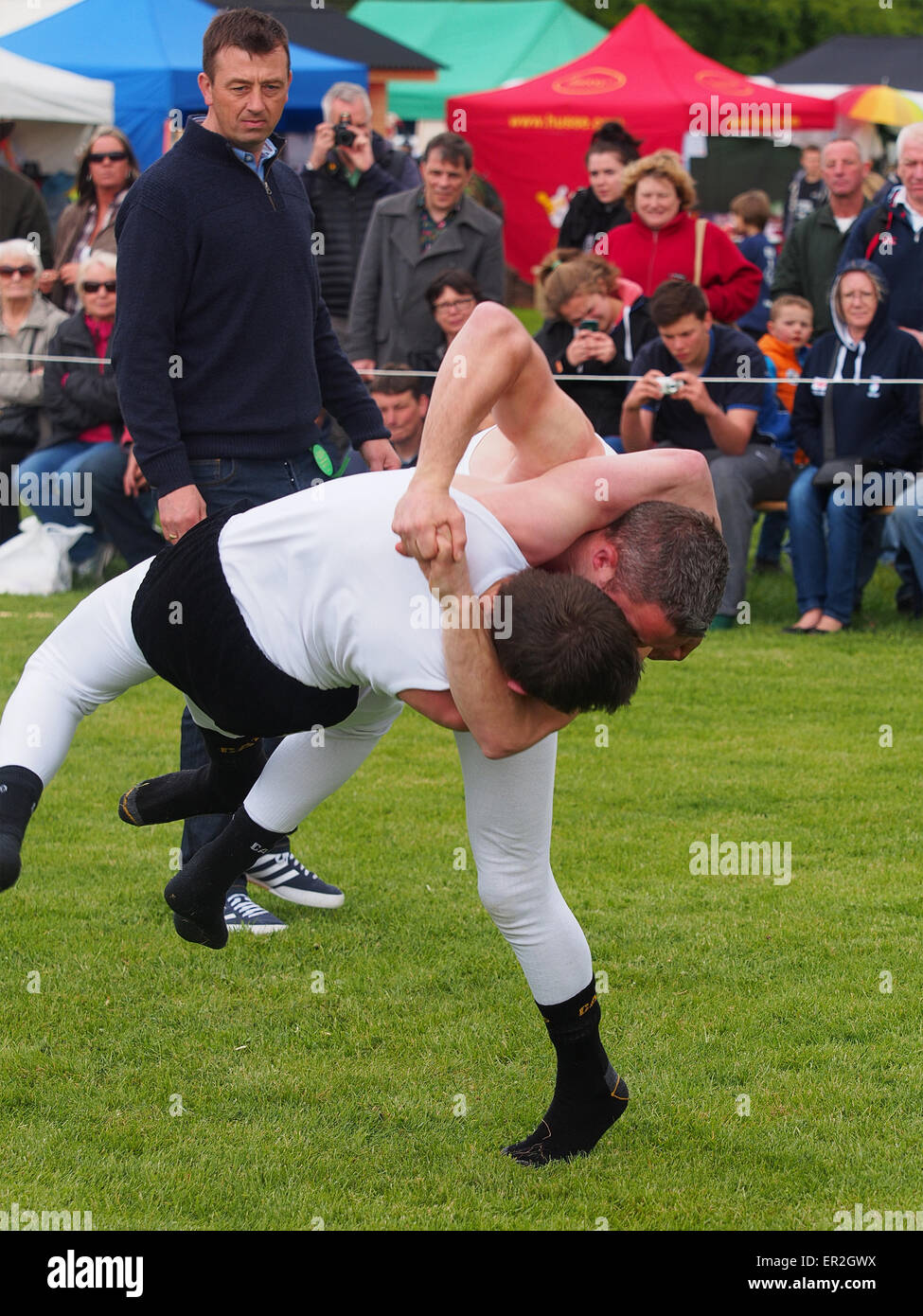 Bywell, UK. 25th May, 2015. Cumberland and Westmorland Wrestling competition at the Northumberland County Show, a traditional agricultural show with displays of livestock, produce and craft from the local area. Cumberland Wrestling is an ancient and well-practised tradition in the north country area of England. Credit:  AC Images/17�Թ����� Live News Stock Photo