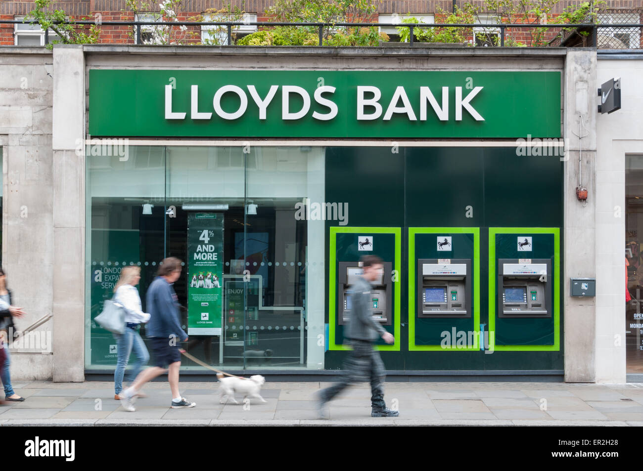 People walking past a Lloyds bank branch in London Stock Photo