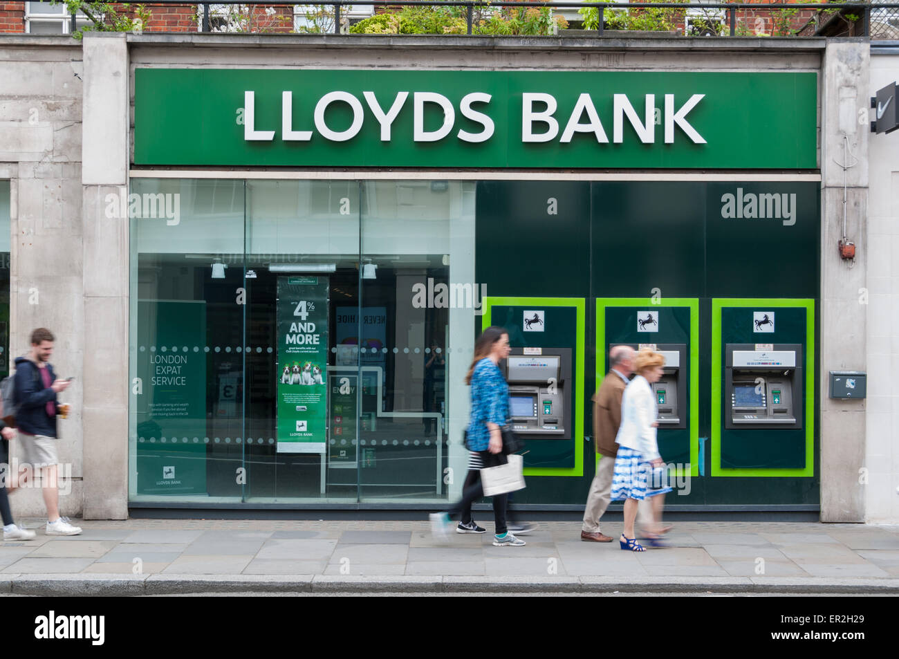 People walking past a Lloyds bank branch in London Stock Photo