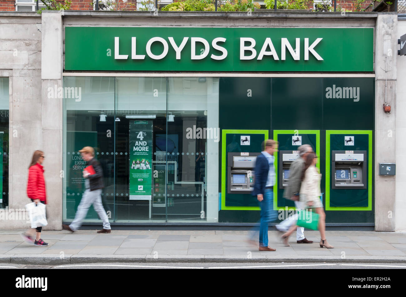 People walking past a Lloyds bank branch in London Stock Photo