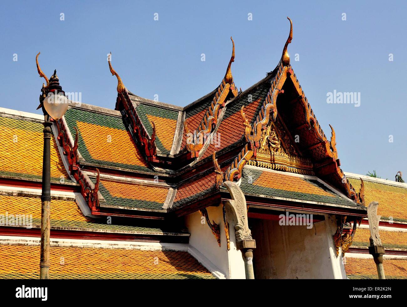 Bangkok, Thailand:  Step gabled roofs with chofah ornaments over the cloister gallery at Wat Suthat Stock Photo