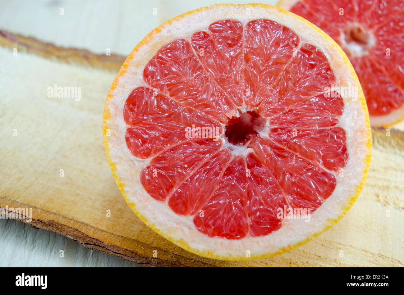 Fresh sliced grapefruit on a wooden board Stock Photo