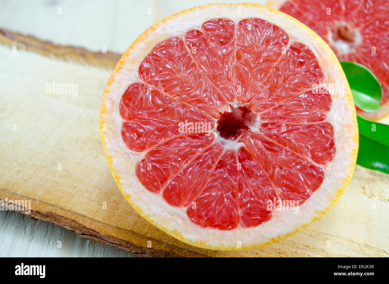Fresh sliced grapefruit on a wooden board Stock Photo