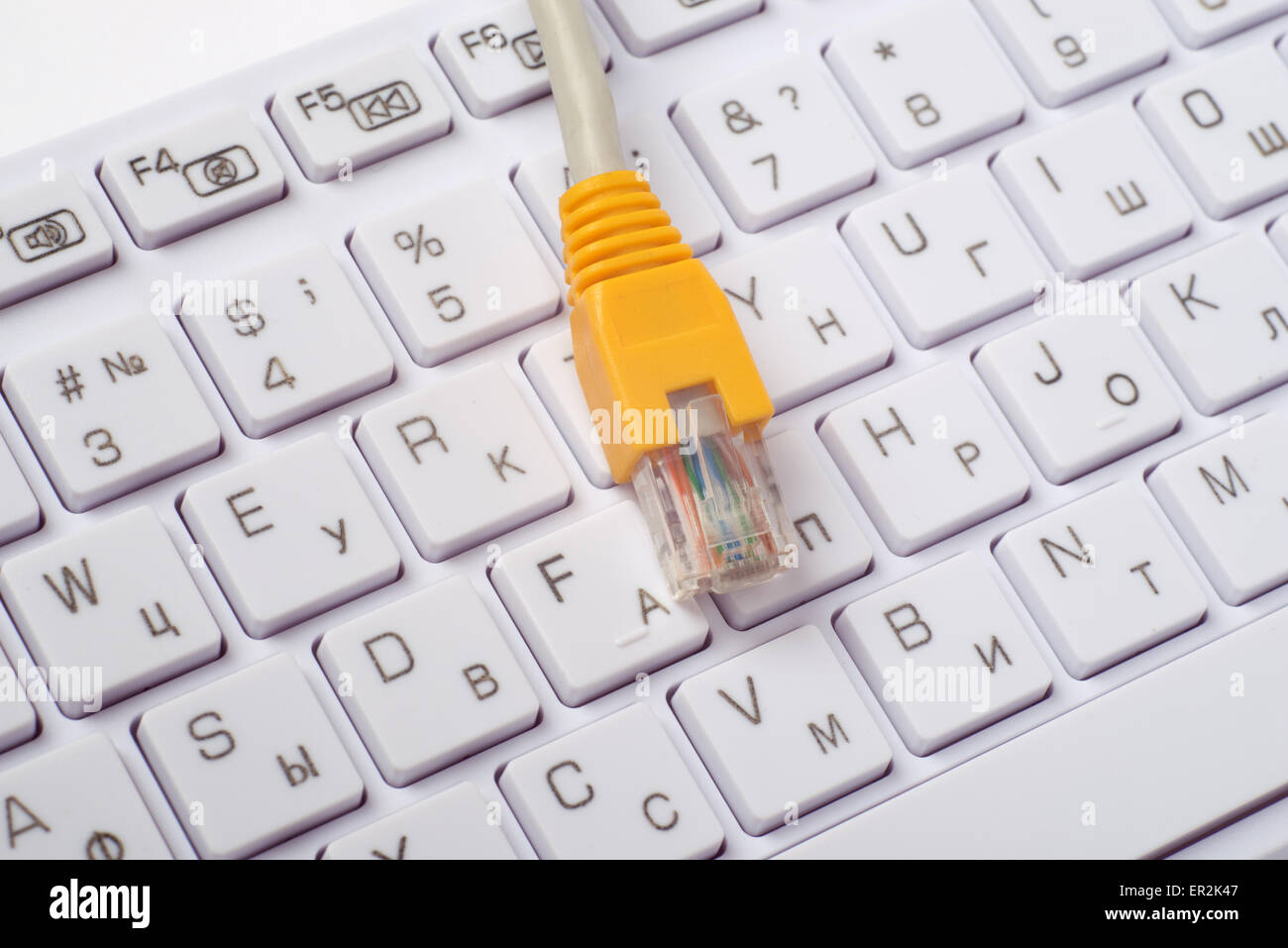 Computer keyboard with yellow cable Stock Photo - Alamy