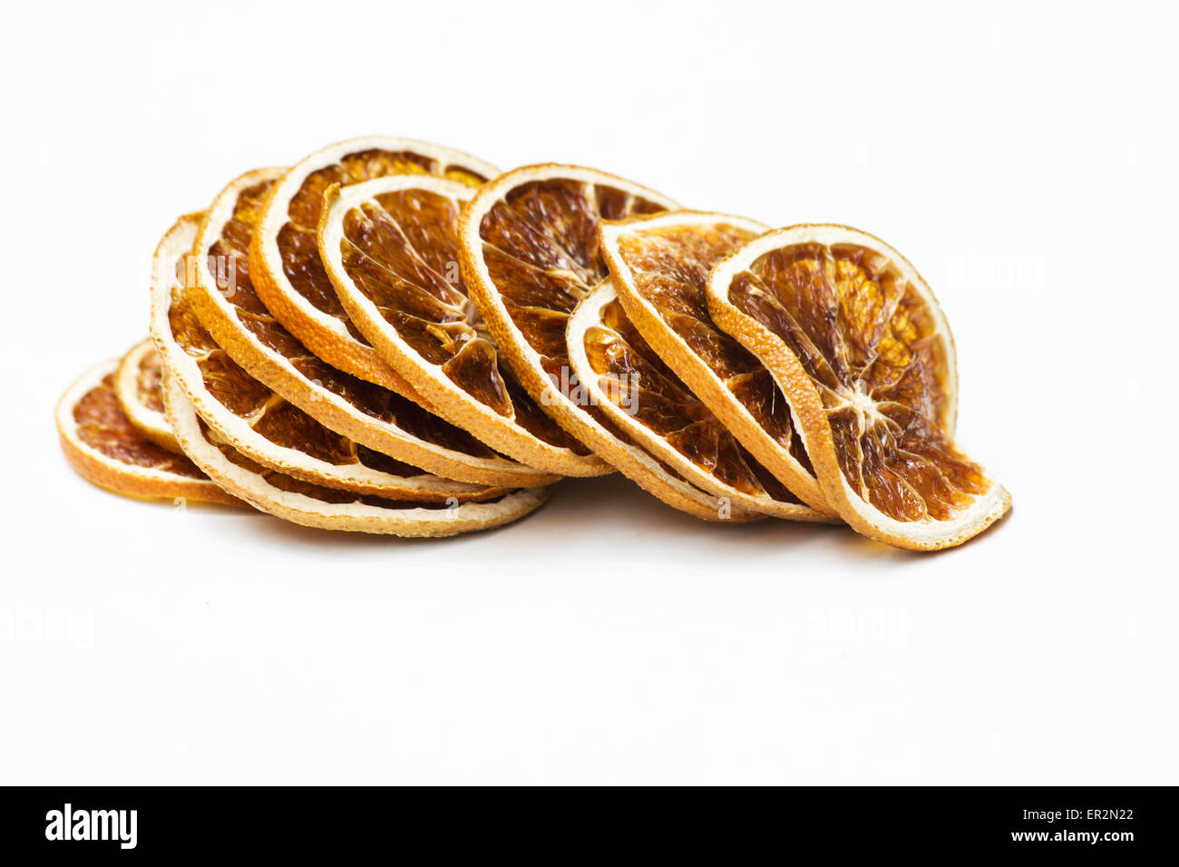 Stack of dried orange slices on white background Stock Photo - Alamy