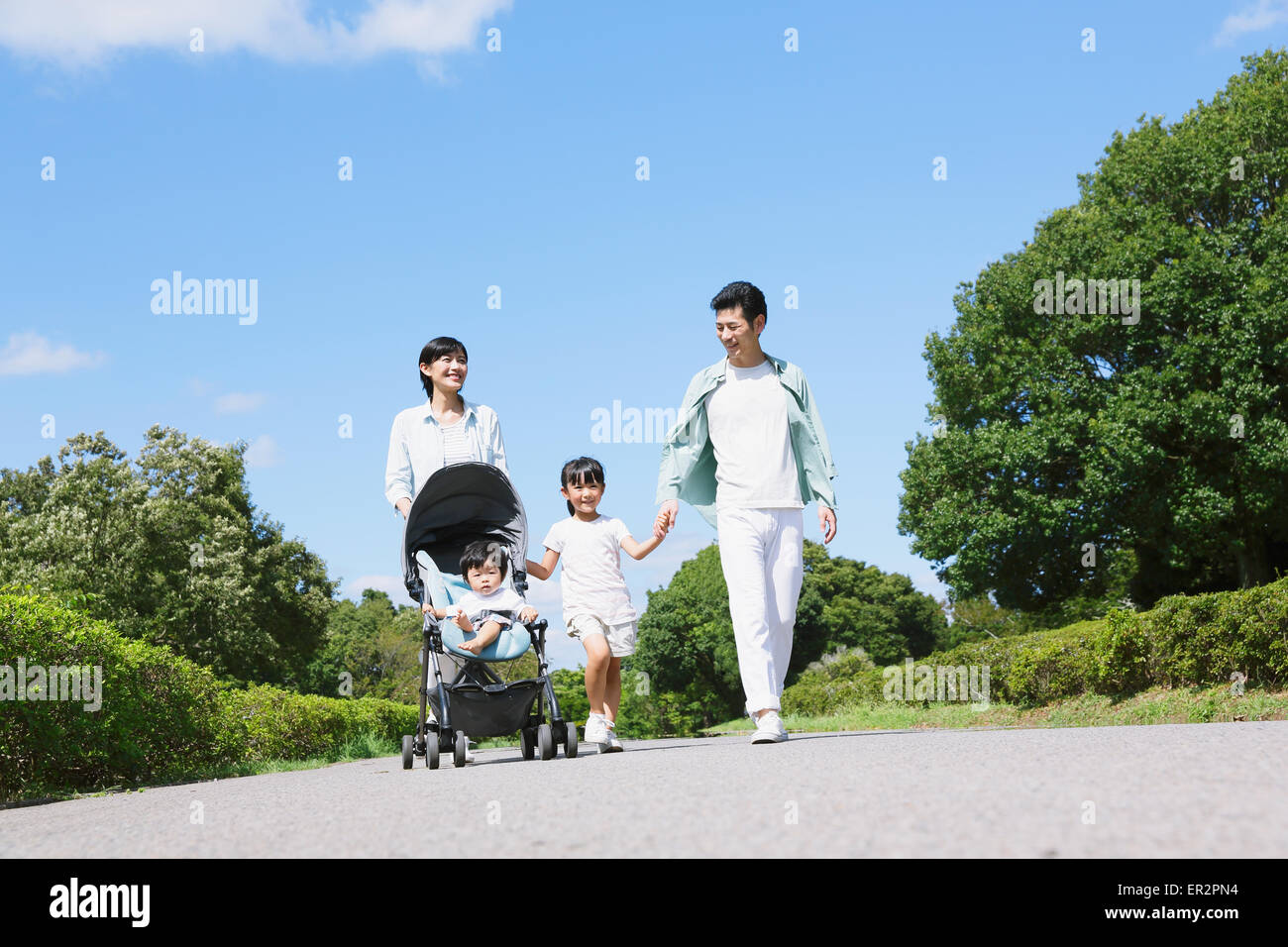Happy Japanese family in a city park Stock Photo