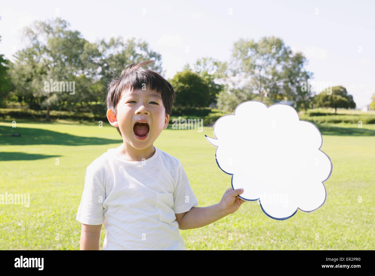 Japanese young boy with whiteboard in a city park Stock Photo Alamy