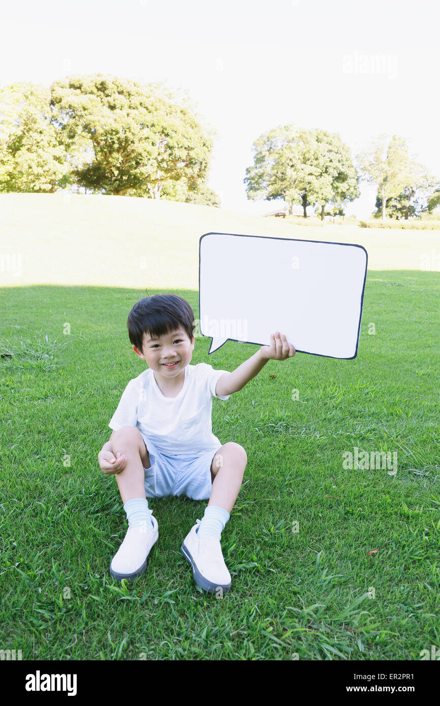 Japanese young boy with whiteboard in a city park Stock Photo Alamy