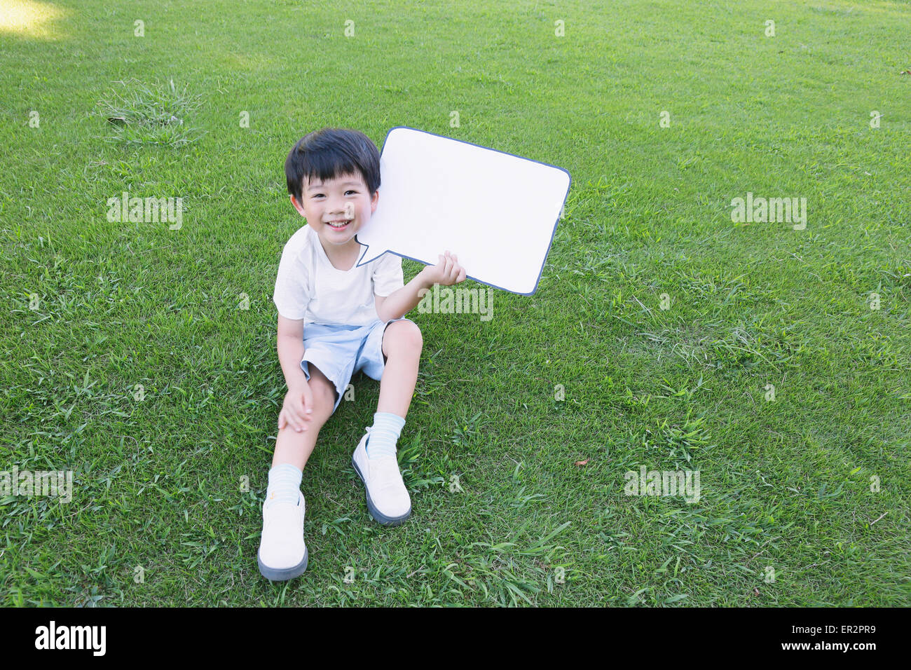 Japanese young boy with whiteboard in a city park Stock Photo Alamy