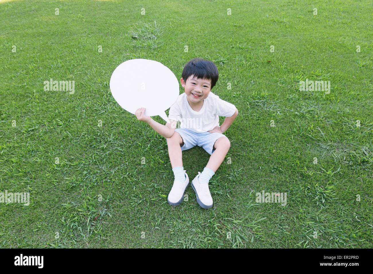 Japanese young boy with whiteboard in a city park Stock Photo Alamy