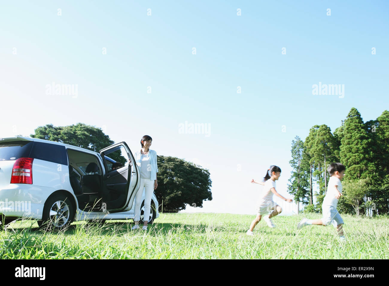 Japanese family with car in a city park Stock Photo