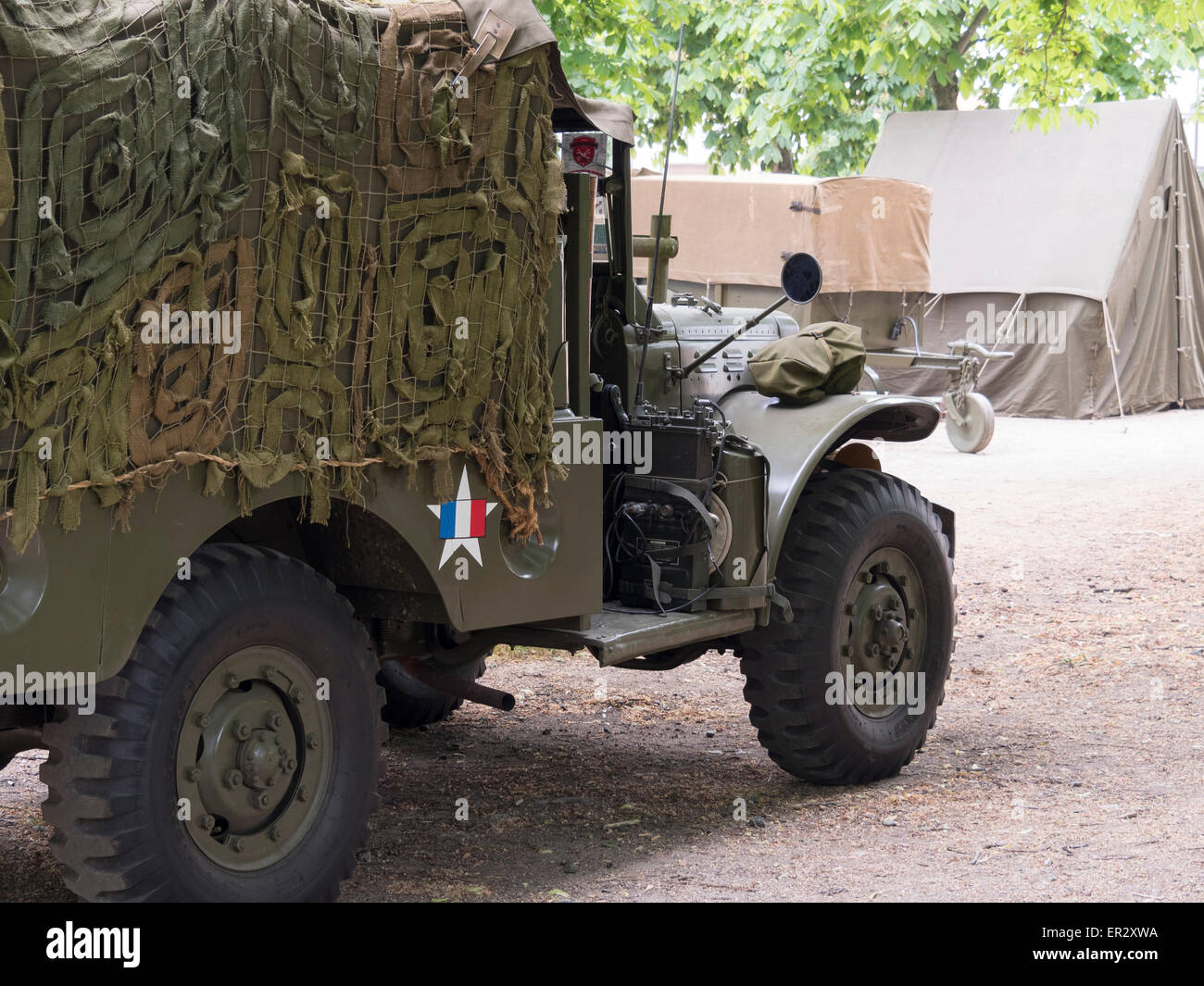 US military truck covered with a net camouflage and the US military star covered with the tricolor French flag (2nd World War) Stock Photo