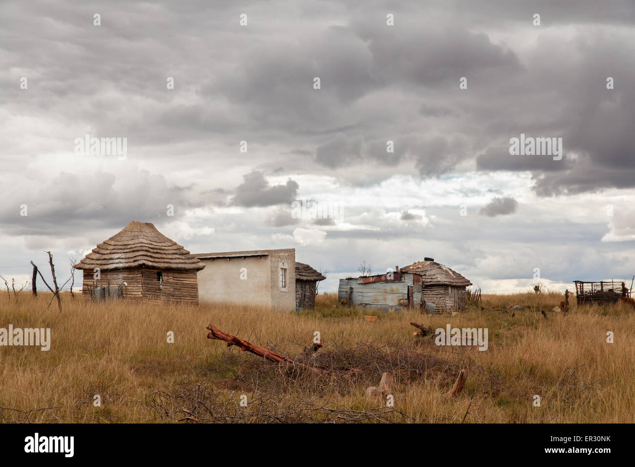 An abandoned farm in the grasslands of Swaziland, Africa with storm clouds overhead. Stock Photo