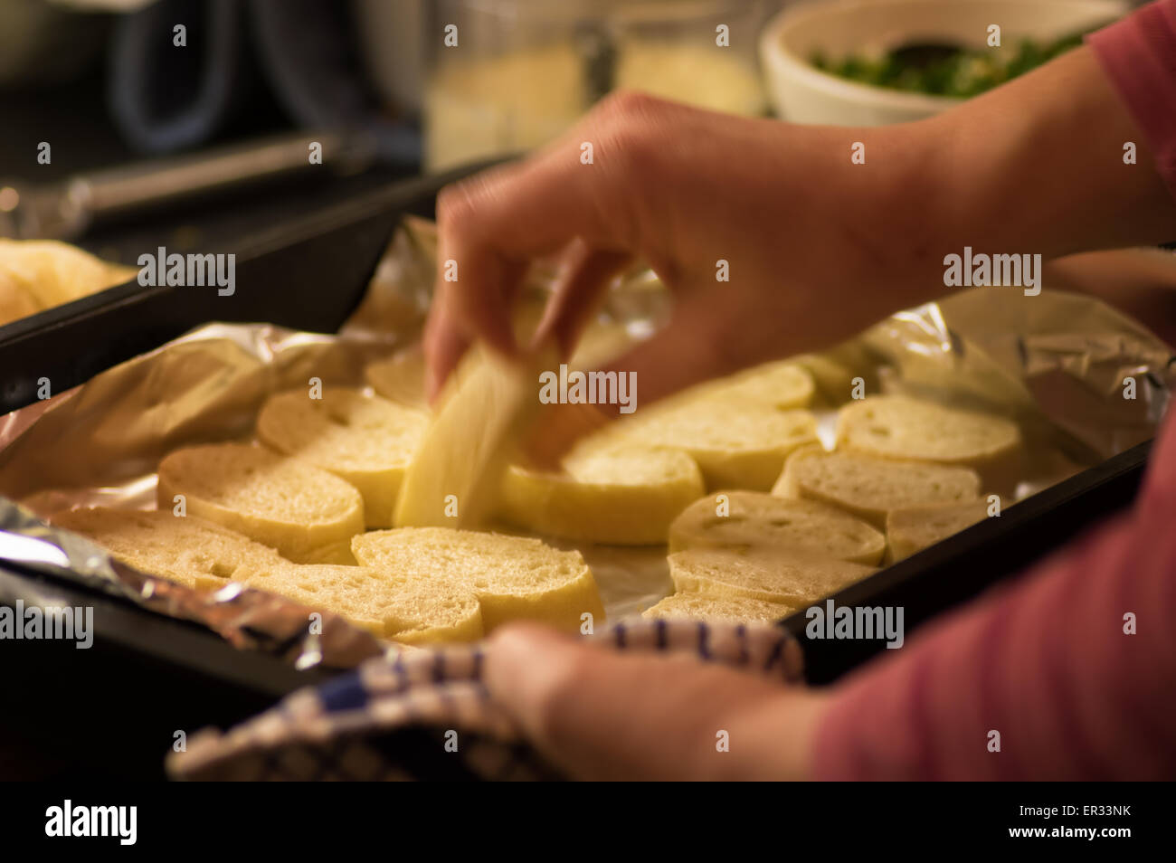 Home made bread, sliced and being turned for warming in the oven Stock