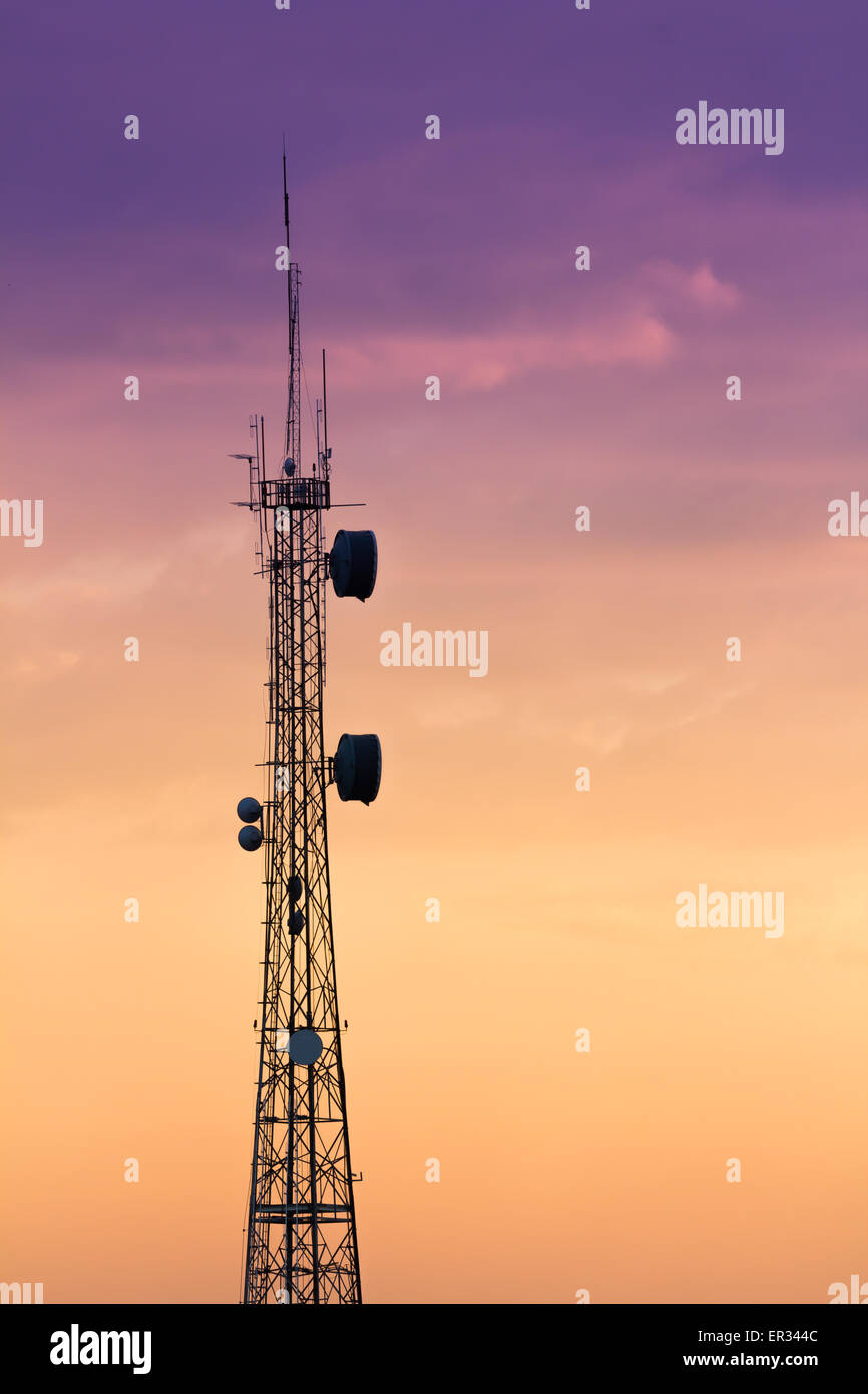 Silhouettes telecommunication tower at sunrise and twilight sky. Stock Photo